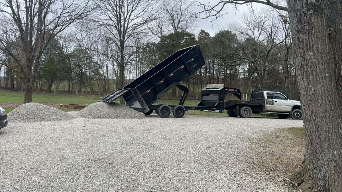CW Concrete - dump trailer delivering gravel for project