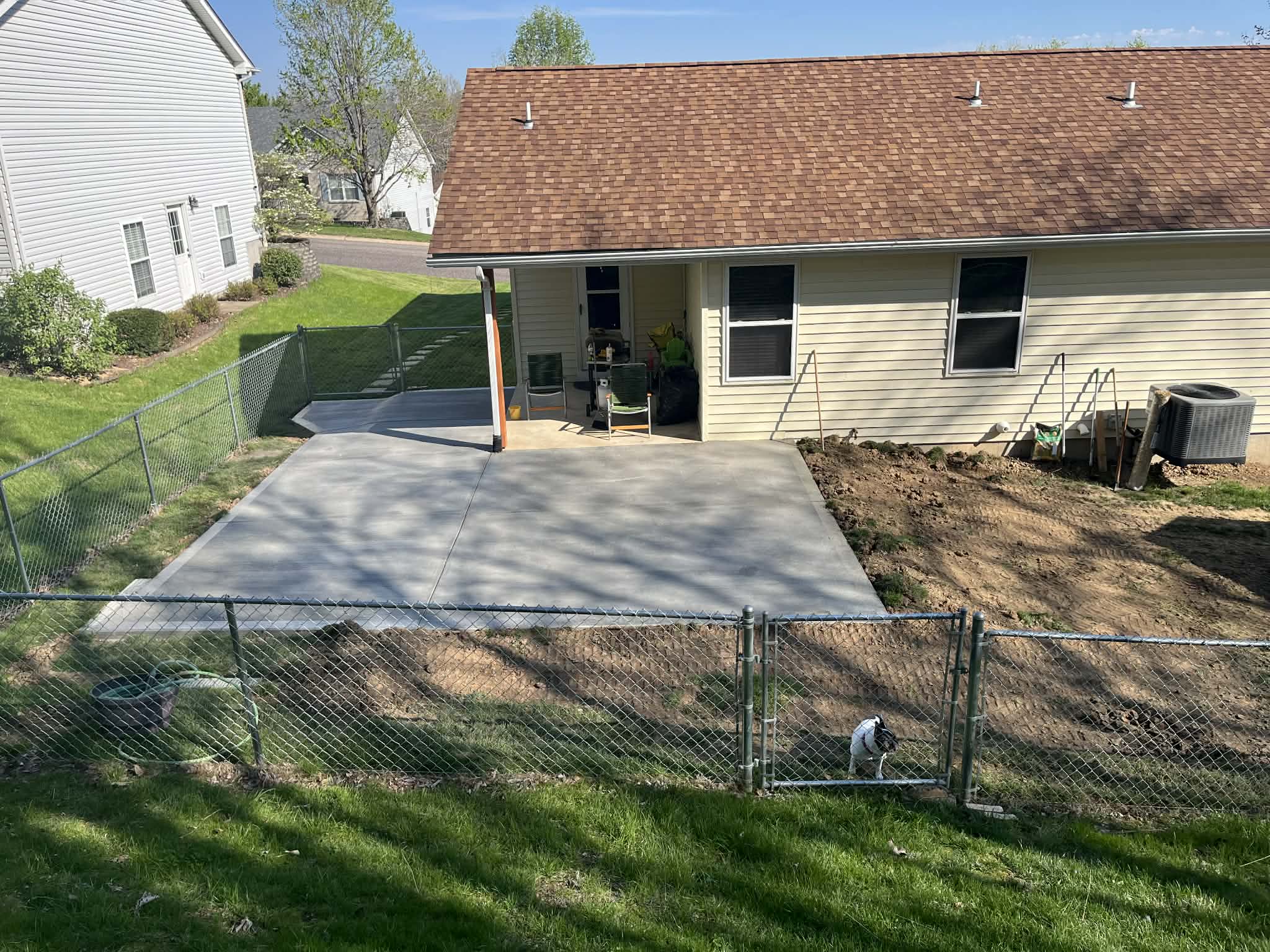 CW Concrete - completed concrete patio behind residential home
