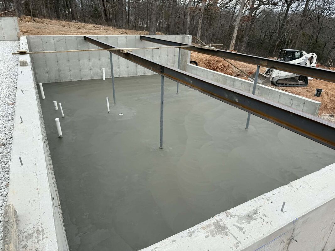 CW Concrete - concrete foundation with steel beam framing and skid steer